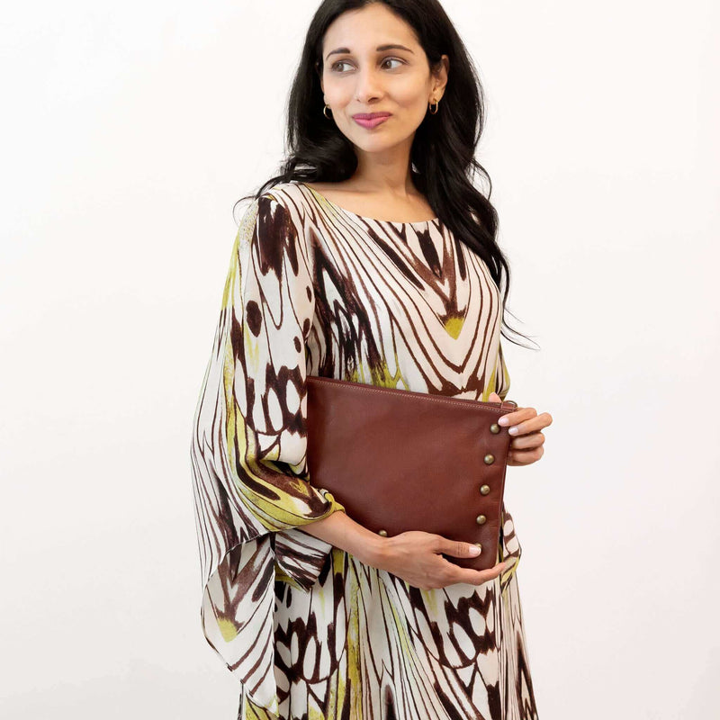 Woman wearing wine studded bag as a clutch bag in studio