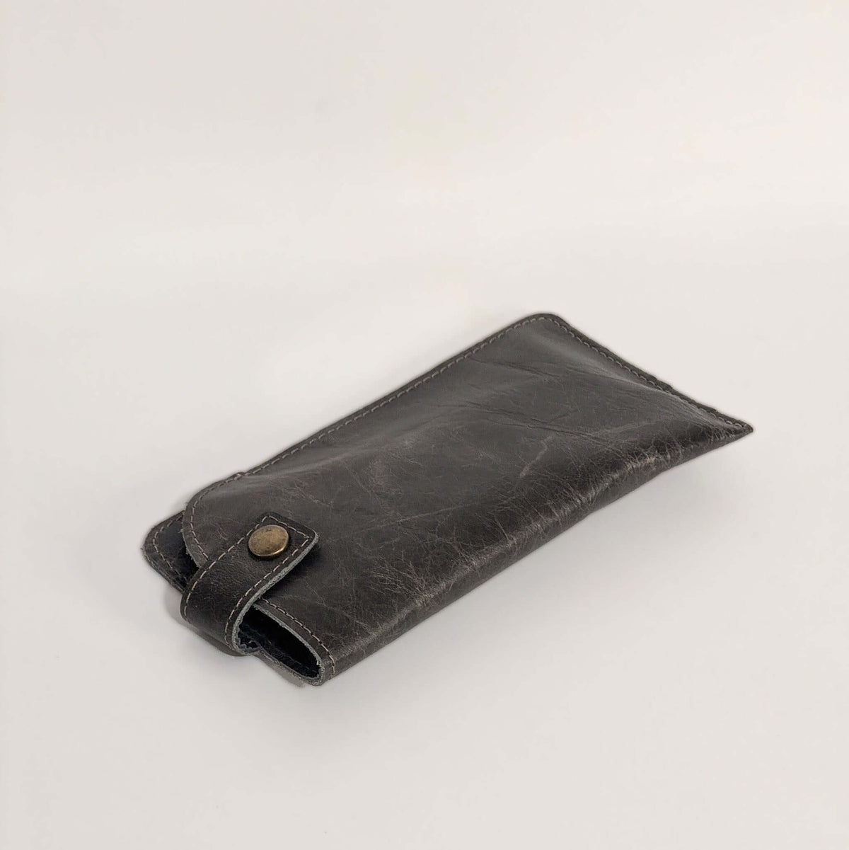 Allison Leather Eyeglass Case in River Rock, slim and padded for protecting lenses, with a secure snap closure.