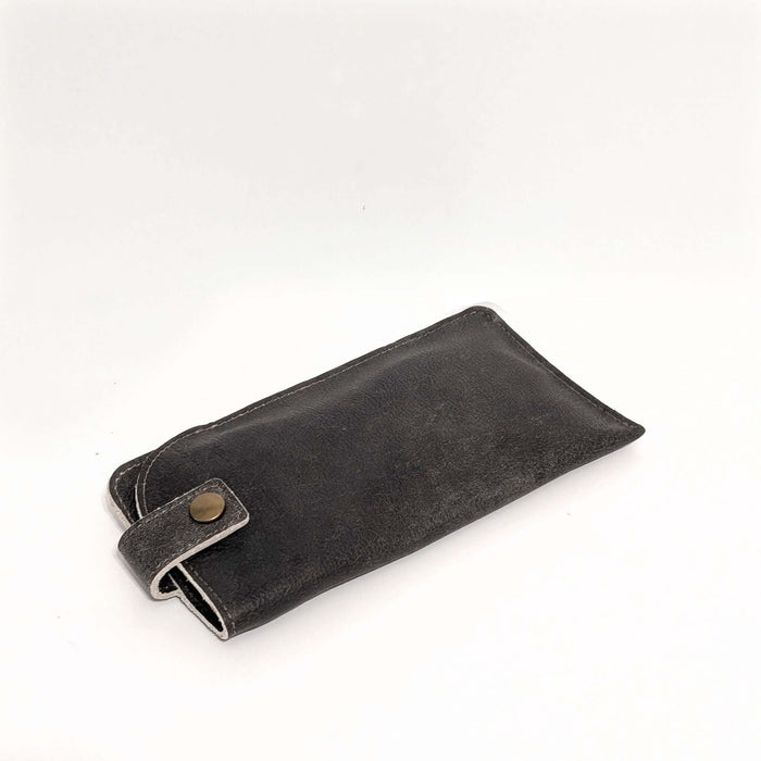 Leather Eyeglass Case in dark color with snap closure for secure storage of glasses.