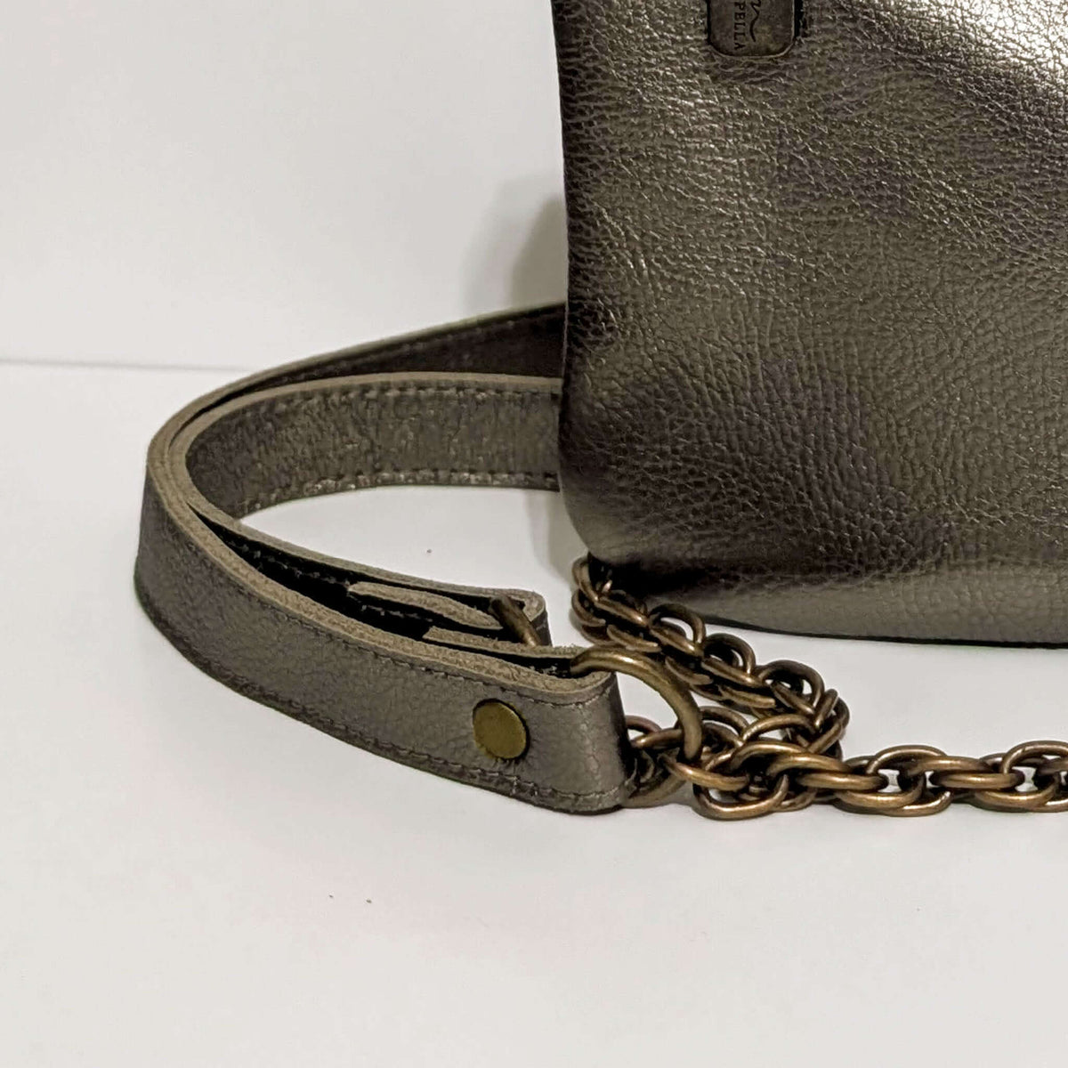 Cher Chain Crossbody in antique pewter, featuring a metallic leather bag with a chain strap detail.