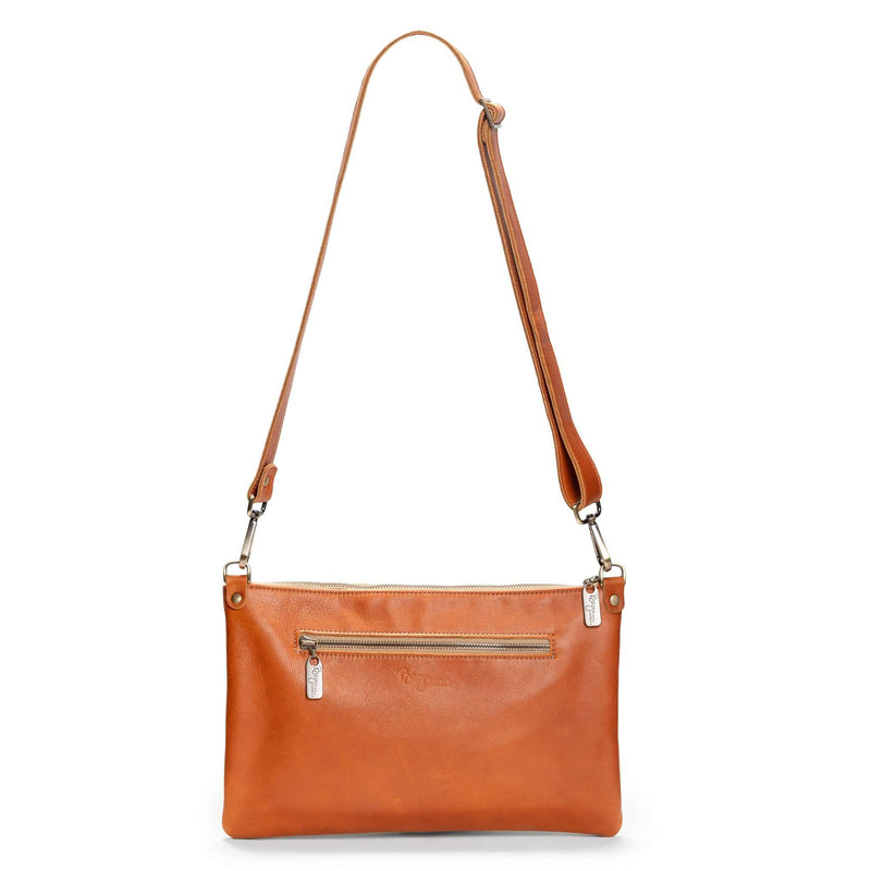 Back view of studded bag in rust full-grain leather convertible clutch-to-crossbody with detachable strap