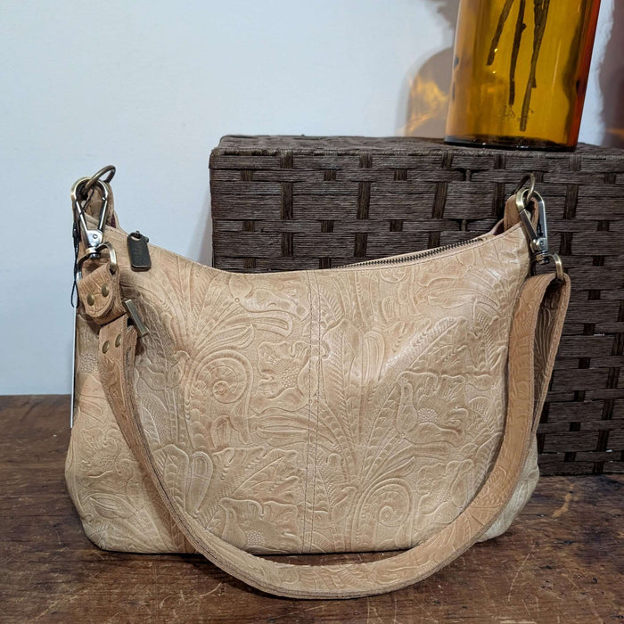 Beige leather hobo handbag with embossed design, crossbody strap, made in USA